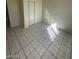 Bedroom showcasing tile flooring, light walls, and closet at 2705 Howard Dr, Las Vegas, NV 89104