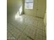 Bedroom showcasing tile flooring, light walls, and natural light from a window at 2705 Howard Dr, Las Vegas, NV 89104
