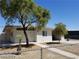 Charming single-story home with a well-maintained lawn, mature trees, and gated entrance at 2705 Howard Dr, Las Vegas, NV 89104