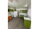 Bright kitchen with gray floors, wood cabinets, appliances, green cabinets and white countertops at 2705 Howard Dr, Las Vegas, NV 89104