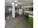 This is an airy kitchen with gray flooring, an overhead fan, lots of cabinet space, and great natural light at 2705 Howard Dr, Las Vegas, NV 89104