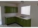 Bright kitchen with retro-style green cabinets, stainless steel faucet and a window at 2705 Howard Dr, Las Vegas, NV 89104