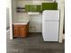 This is a partial view of a kitchen showing cabinets, gray flooring, and a refrigerator at 2705 Howard Dr, Las Vegas, NV 89104