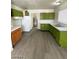 Bright kitchen featuring wood and green cabinets, sleek appliances and modern vinyl floors at 2705 Howard Dr, Las Vegas, NV 89104