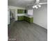 The kitchen is well-lit with gray floors, green cabinets, a dual sink, and a ceiling fan at 2705 Howard Dr, Las Vegas, NV 89104