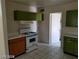 Kitchen showcases green and wood cabinets, white countertops and tile flooring at 2705 Howard Dr, Las Vegas, NV 89104