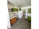 This is a partial view of a kitchen showing cabinets, gray flooring, and a refrigerator at 2705 Howard Dr, Las Vegas, NV 89104