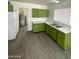 The kitchen has a dual basin sink with lots of cabinet space, gray flooring, and an adjacent room with a water heater at 2705 Howard Dr, Las Vegas, NV 89104