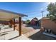 A large backyard with a covered patio, multiple storage sheds, and ample open space at 3212 Osage Ave, Las Vegas, NV 89101