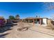 A spacious backyard featuring a covered patio, storage sheds, and an open layout at 3212 Osage Ave, Las Vegas, NV 89101