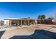 Spacious backyard featuring a covered patio, brick accents, and ample room for outdoor activities at 3212 Osage Ave, Las Vegas, NV 89101