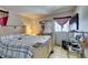 The bedroom features tile flooring and is well-lit by a large window and fixtures at 3212 Osage Ave, Las Vegas, NV 89101
