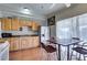 The well-lit kitchen boasts wood cabinets, an eat-in dining space, and efficient appliances at 3212 Osage Ave, Las Vegas, NV 89101