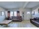 Spacious living room with tile flooring, natural light, and comfortable seating at 3212 Osage Ave, Las Vegas, NV 89101