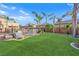 Beautiful backyard with lush green lawn, mature trees, and privacy fence at 3213 Salutare Ct, North Las Vegas, NV 89031