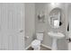 Bathroom with a pedestal sink, toilet, and neutral-colored walls and flooring at 3213 Salutare Ct, North Las Vegas, NV 89031