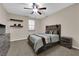 Carpeted bedroom with decorative shelves, ceiling fan, and rustic decor at 3213 Salutare Ct, North Las Vegas, NV 89031