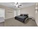 This bedroom features neutral walls, a ceiling fan, carpeted floors, and floating shelves at 3213 Salutare Ct, North Las Vegas, NV 89031