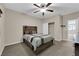 Carpeted bedroom with decorative shelves, ceiling fan, and rustic decor at 3213 Salutare Ct, North Las Vegas, NV 89031