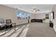 Large bonus room with carpet, windows, desk, sectional sofa, and plenty of natural light at 3213 Salutare Ct, North Las Vegas, NV 89031