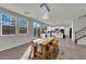 Bright dining area features a stylish chandelier, a wooden table, and sliding door access to the backyard at 3213 Salutare Ct, North Las Vegas, NV 89031