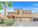 Inviting two-story home featuring an arched entry, desert landscaping and a two-car garage at 3213 Salutare Ct, North Las Vegas, NV 89031