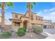 Charming two-story home with desert landscaping, an arched entryway, and a two-car garage at 3213 Salutare Ct, North Las Vegas, NV 89031