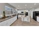 Kitchen features an island with seating, granite countertops, stainless appliances, and white cabinetry at 3213 Salutare Ct, North Las Vegas, NV 89031