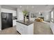 Kitchen island with a granite countertop, white cabinets, and views of dining and living spaces at 3213 Salutare Ct, North Las Vegas, NV 89031