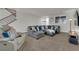 Spacious living room with large sectional, plush carpeting, and modern furnishings at 3213 Salutare Ct, North Las Vegas, NV 89031