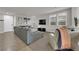 Bright living room with comfortable seating, tile floors, carpet, and a large TV at 3213 Salutare Ct, North Las Vegas, NV 89031