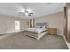 Large main bedroom with a tufted headboard bed, ceiling fan, and ensuite bathroom at 3213 Salutare Ct, North Las Vegas, NV 89031