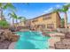 Inviting pool features a rock waterfall, a spa, and ample deck space for outdoor enjoyment at 3213 Salutare Ct, North Las Vegas, NV 89031