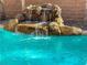 Detail of the rock waterfall feature of the home's private pool at 3213 Salutare Ct, North Las Vegas, NV 89031