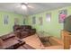 Living room featuring hardwood floor, plush sofas, and soft green walls at 3255 Liahona Way, Las Vegas, NV 89121