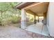 Covered patio in the backyard with brick pillars and rock landscaping features at 3504 Frigatebird Ln, North Las Vegas, NV 89084