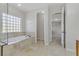 This spacious bathroom features a soaking tub with a glass block window at 3504 Frigatebird Ln, North Las Vegas, NV 89084