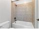 Bright bathroom featuring a tiled shower and tub combination with bronze fixtures at 3504 Frigatebird Ln, North Las Vegas, NV 89084