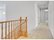 Upstairs hallway with carpet flooring and wooden railing along the stairs at 3504 Frigatebird Ln, North Las Vegas, NV 89084