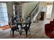 Dining area featuring a modern table set, gray stairs, and contemporary decor at 3630 Mckinley Ave, Las Vegas, NV 89121