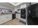 Bright kitchen featuring white cabinets and modern black appliances at 3630 Mckinley Ave, Las Vegas, NV 89121