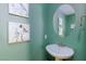 Stylish powder room with a round mirror and modern vanity at 3732 Via Gennaro, Henderson, NV 89044