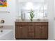 This bathroom offers a double vanity, modern fixtures, and a plant at 3732 Via Gennaro, Henderson, NV 89044