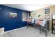This bedroom has dark blue accent wall and a fun art at 3732 Via Gennaro, Henderson, NV 89044