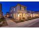 Beautiful home exterior at twilight, featuring a charming arched porch and cozy lighting at 3732 Via Gennaro, Henderson, NV 89044