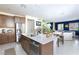 Open kitchen features a quartz countertop island and stainless steel appliances at 3732 Via Gennaro, Henderson, NV 89044