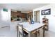 Open kitchen featuring a breakfast bar, stainless steel appliances and dining area at 3732 Via Gennaro, Henderson, NV 89044