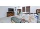 This main bedroom has great natural light, a tv, and an office chair at 3732 Via Gennaro, Henderson, NV 89044