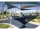 Community playground featuring modern play equipment with a shade sail and accessible rubberized surface at 3732 Via Gennaro, Henderson, NV 89044