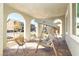 Arched porch features a porch swing, stylish seating, and a brick-paved floor at 3732 Via Gennaro, Henderson, NV 89044